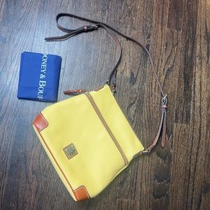Dooney and Bourke soft yellow purse. Brand new with dust bag.
